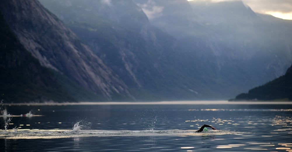 Triathletes swimming in cold water at Norsemen Xtreme Triathlon