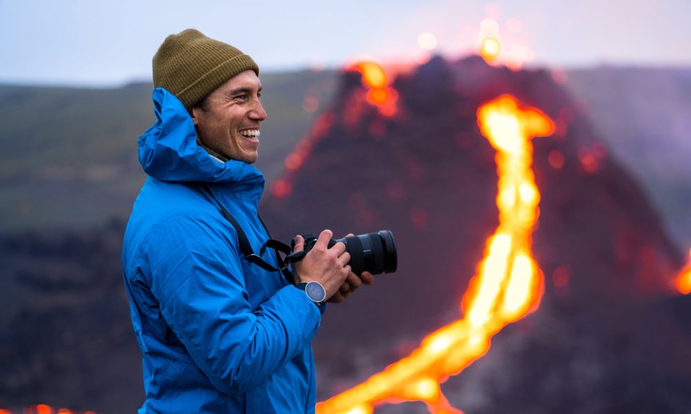 Photographer Chris Burkard on the side of erupting volcano in Iceland