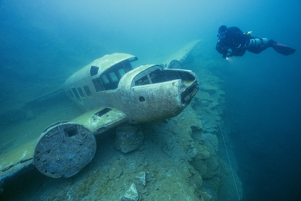 A small plane lies in a freshwater quarry in Quebec, one of the first stops on their expedition.